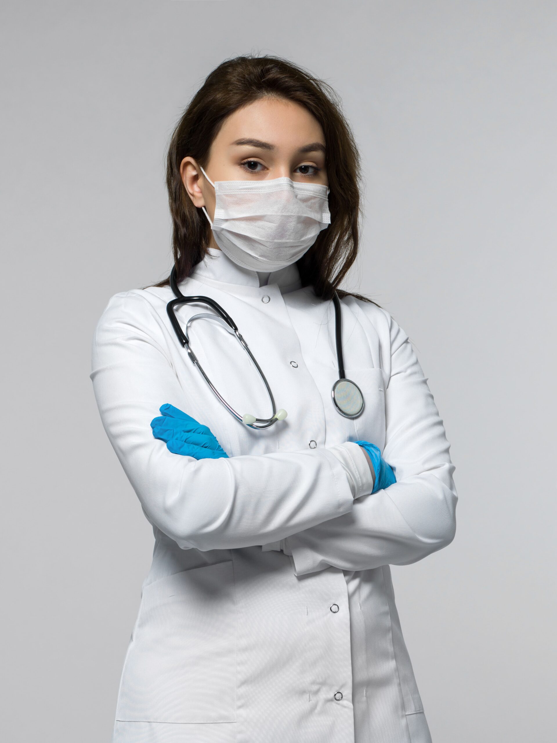 nurse-with-stethoscope-white-medical-uniform-white-protective-sterile-mask-min